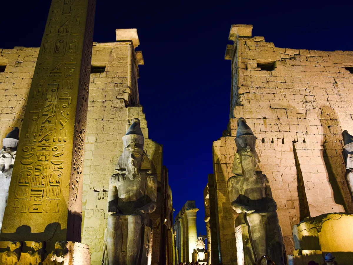 Luxor Temple illuminated at night, with its ancient statues and hieroglyphs